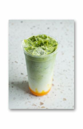 A view of a layered matcha mango milk tea.