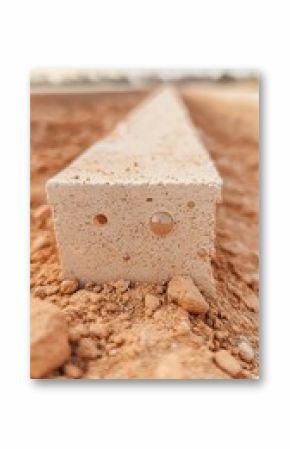 Beige Porous Concrete Block in Sandy Ground