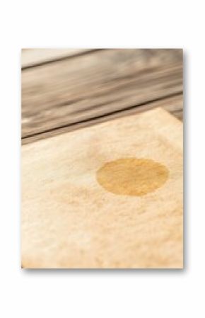 Circular Stain on Aged Paper on Wooden Surface