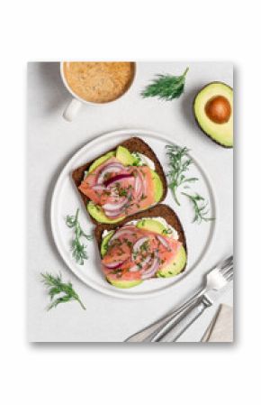 Smoked salmon avocado sandwich on light background. Black whole grain bread, avocado, salted salmon and dill for healthy breakfast