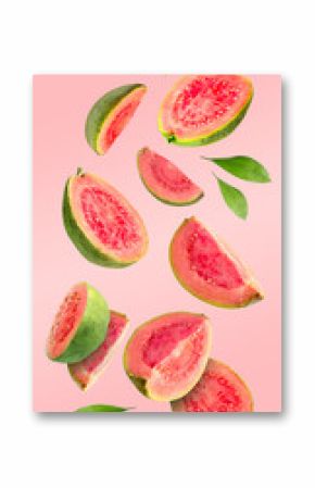 Fresh guava fruits and leaves falling on pastel pink background