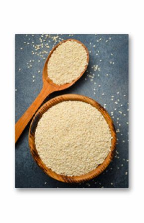 Wooden bowl with sesame seeds. On a gray concrete background. Close-up. Organic food.