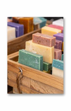 A close-up of colorful artisanal Moroccan soaps stacked neatly in wooden boxes