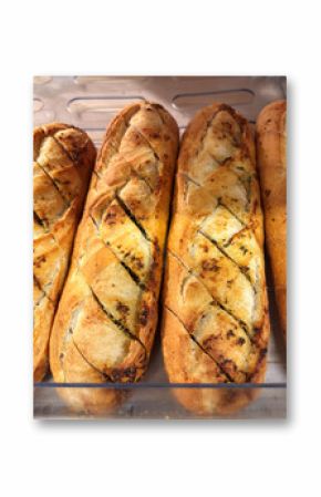 French baguette with garlic and herbs on a shelf in a supermarket
