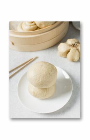 Overhead view of steamed bun on a white countertop, top view of mantou on a white background, process of making steamed milk buns
