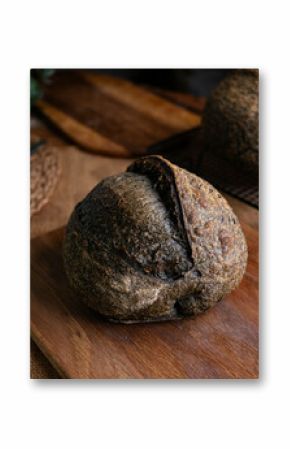 loaf of fresh baked black charcoal sourdough bread. Black ciabatta bread with activated carbon.