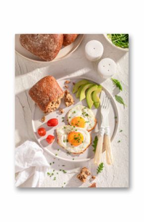 British and homemade breakfast with buns and fried eggs.