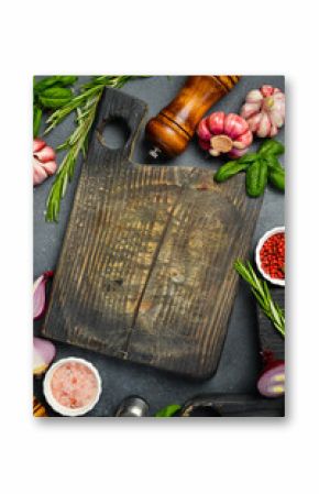 Cooking background. Top view. Spices, vegetables and seasonings on the kitchen table.