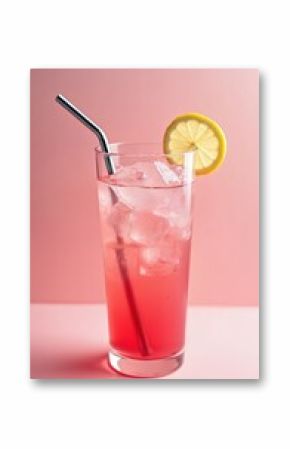 Glass filled with cold pink lemonade, ice cubes, metal straw and lemon slice. Refreshing summer beverage in soft focus pink background. Sweet, juicy drink perfect for hot weather.