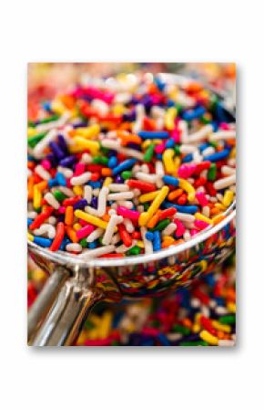 Glass scoop filled with multicolored sprinkles