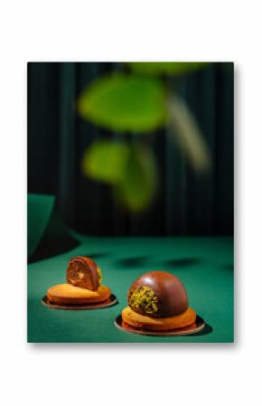Delicious dessert duo showcases chocolate and pistachio treats on green backdrop