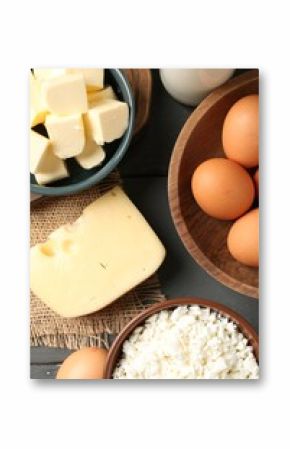 Different dairy products and eggs on grey wooden table, flat lay