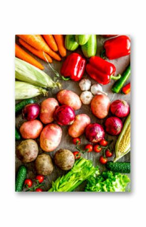 Fresh vegetables still life.  Potato, cucumber, beet carrot, greenery on stone background top-down