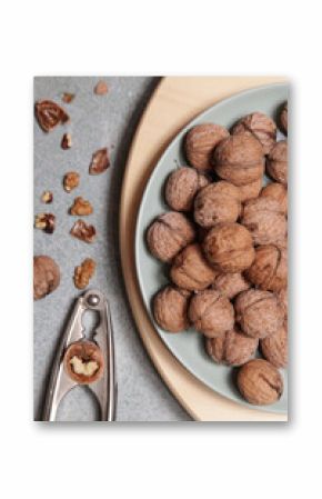 Whole and cracked walnuts and nutcracker
