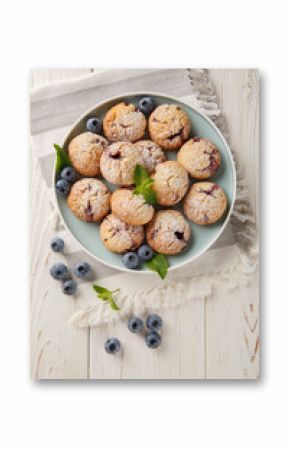 Vegetarian Blueberry Cookies sprinkled with powdered sugar closeup in the bowl on the table. Vertical top view from above