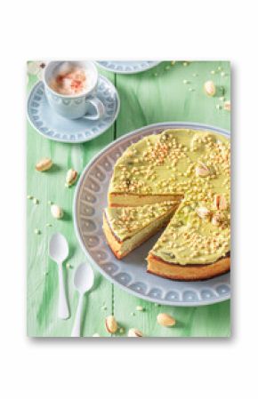 Homemade pistachio cheesecake served on blue porcelain.