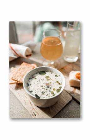 Maine clam chowder, clams, lobster, oysters plated at a restaurant with gorgeous light