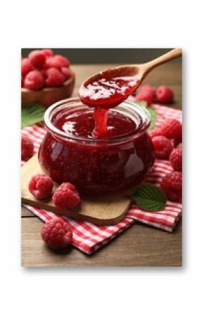 Taking tasty jam with spoon on wooden table, closeup