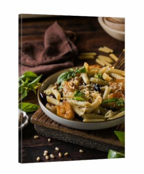 Italian pasta with shrimp and basil on plate, gourmet seafood dish
