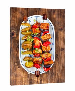 Grilled meat skewers with potatoes.