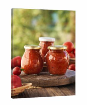 Three jars of homemade tomato and sweet pepper relish (ajvar-style vegetable spread, chutney or bruschetta topping)