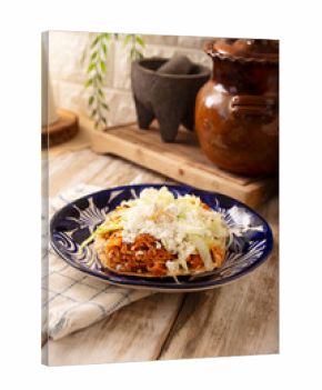 Chicken tinga toast, a traditional Mexican home-cooked dish consisting primarily of chicken cooked with chipotle chili and lots of onion, is traditionally eaten on "Tostadas" (fried corn tortillas).