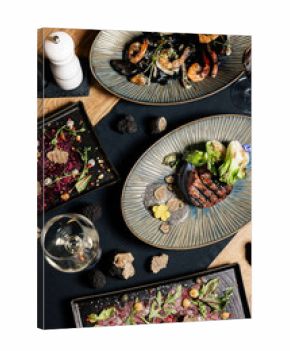 Assorted gourmet dishes presented as an upscale dining selection Fine dining food assortment showcased on elegant plates Premium restaurant dishes featured in a gourmet tasting spread