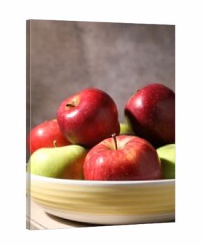Fresh red and green apples in bowl on wooden table against grey background, closeup