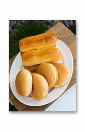 Sausage rolls, hot dogs and burger buns in a plate, cooking bbq