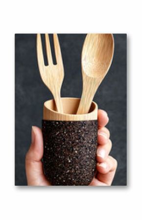 Hand Holding Eco-Friendly Wooden Cutlery Set in Black Glitter Holder