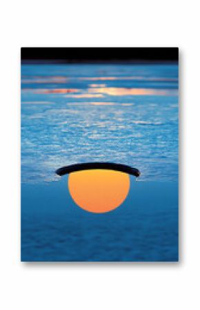 Melting Ice on a Frozen Lake at Sunset
