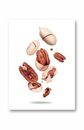 Crushed pecan nuts in the air close-up isolated on white background