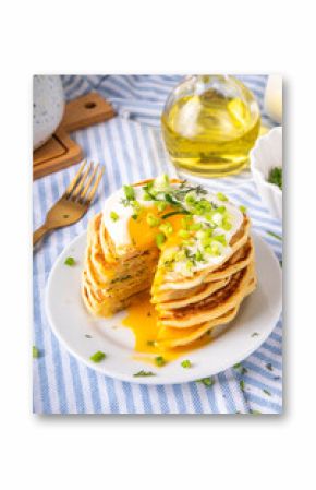 Tasty savory breakfast pancakes with spring green onion and fried eggs