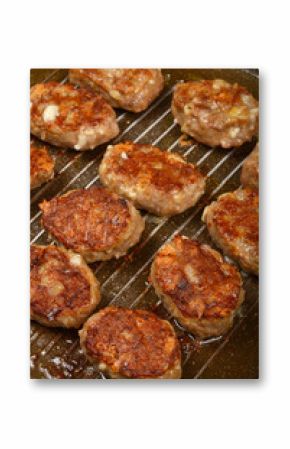 A close-up, overhead shot shows savory minced meat and cheese patties browning on a dark grill pan during cooking