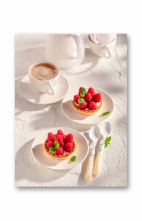 Sweet and delicious mini tart made of cream and raspberries.