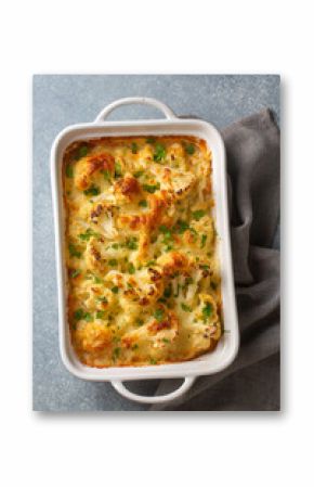 Casserole Cauliflower baked with cheese sauce in a pot close-up on a wooden table. Horizontal top view from above. Cauliflower gratin