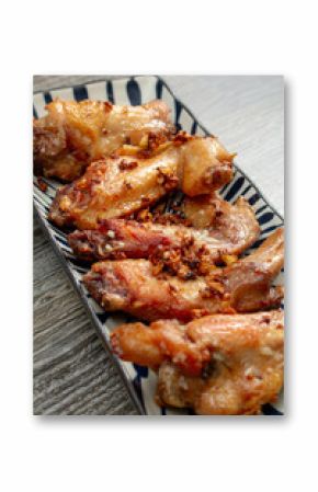 A view of a plate of garlic chicken wings.