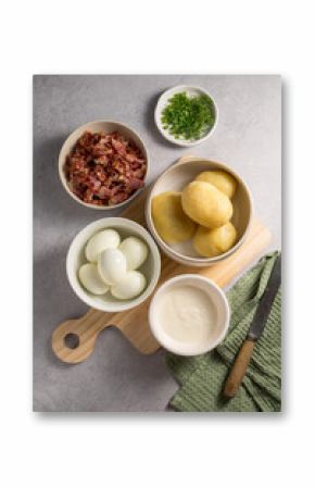 Cooking egg potato salad with bacon and fresh herbs in a plate