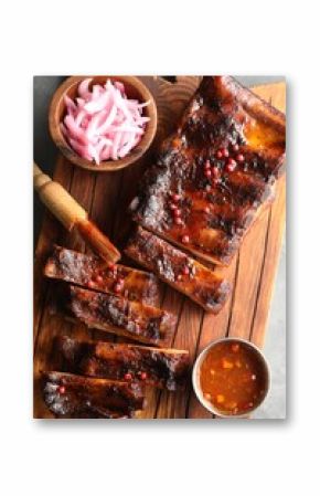 Delicious spare ribs, onion and sauce on grey table, top view