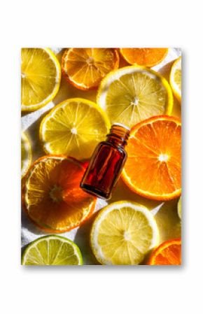 Fresh citrus slices with an essential oil bottle for natural wellness