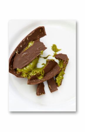 pistachio paste, Dubai chocolate shell cracked open revealing vibrant green filling in gourmet dessert creation