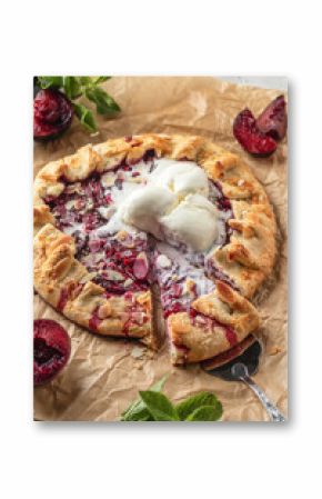 Sliced galette or pie with plums and almonds served with ice cream scoops on parchment paper background. Summer traditional homemade sweet pastries