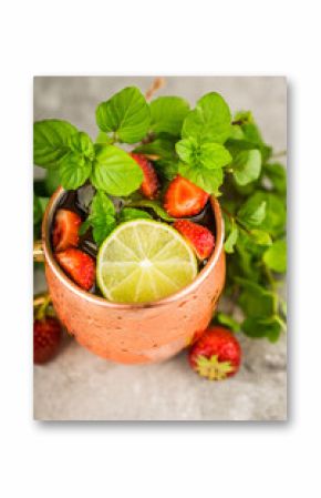 Refreshing Moscow mule cocktail with strawberries on the rustic background. Selective focus.