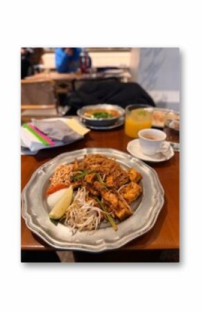 Close-Up of Pad Thai with Tofu and Lime in a Cozy Restaurant