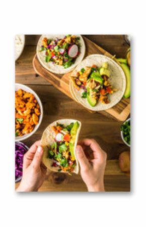 Authentic cooking at home: Hands assembling tacos with vibrant toppings, exuding culinary passion, showcase an authentic cooking experience