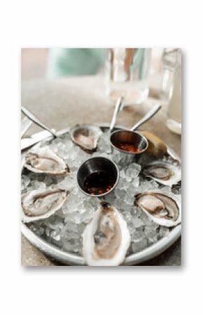 Maine clam chowder, clams, lobster, oysters plated at a restaurant with gorgeous light