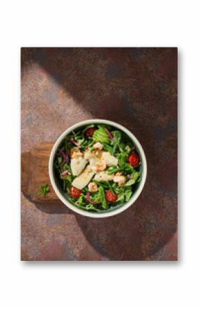 Green salad with calamari and shrimp, pine nuts, bright natural light, overhead minimal composition