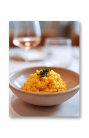Elegant risotto, vibrant  creamy, topped with fresh herbs, in a refined setting. Perfect for illustrating fine dining, gourmet meals  culinary arts concepts.