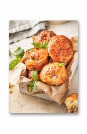 Savory egg muffins with bazil, ham and cheese in white wooden box on kitchen table background. Healthy and quick morning breakfast