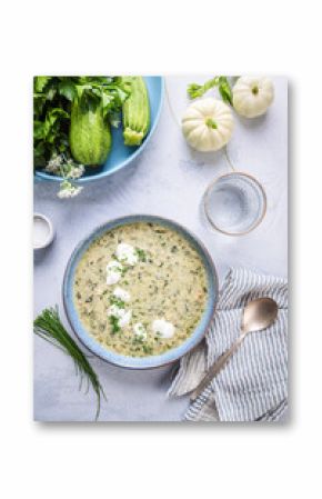 Cold summer zucchini and yogurt soup with chives on kitchen table, zucchini gazpacho